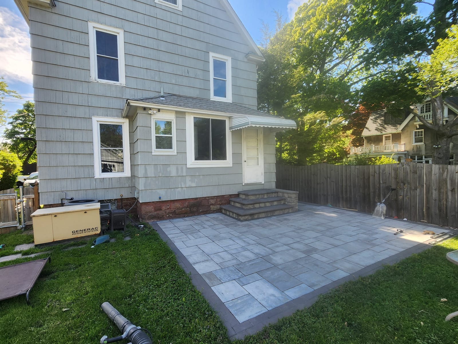 Backyard paver patio with steps
